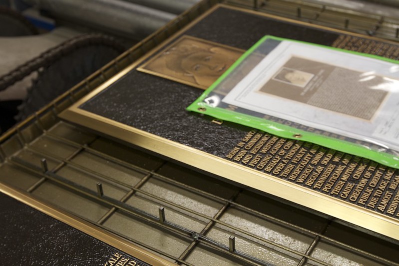 Finishing of bronze photo relief plaque with satin finish and diamond shield clear coat