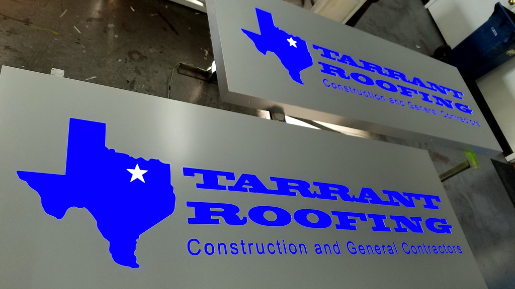 84" x 30" x 3'' deep fabricated metal panel in Painted Silver finish with Reverse cut out custom shape logo and lettering to show through translucent blue insert