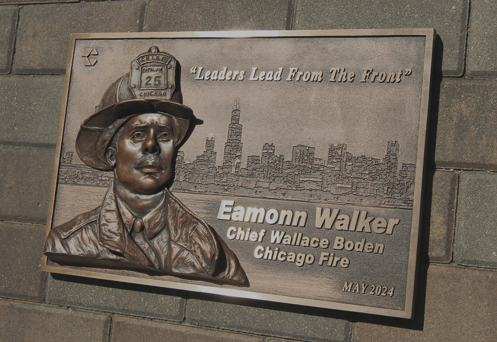 Bas relief bronze sculpture image assembled on a bronze full photo relief image plaque with raised lettering