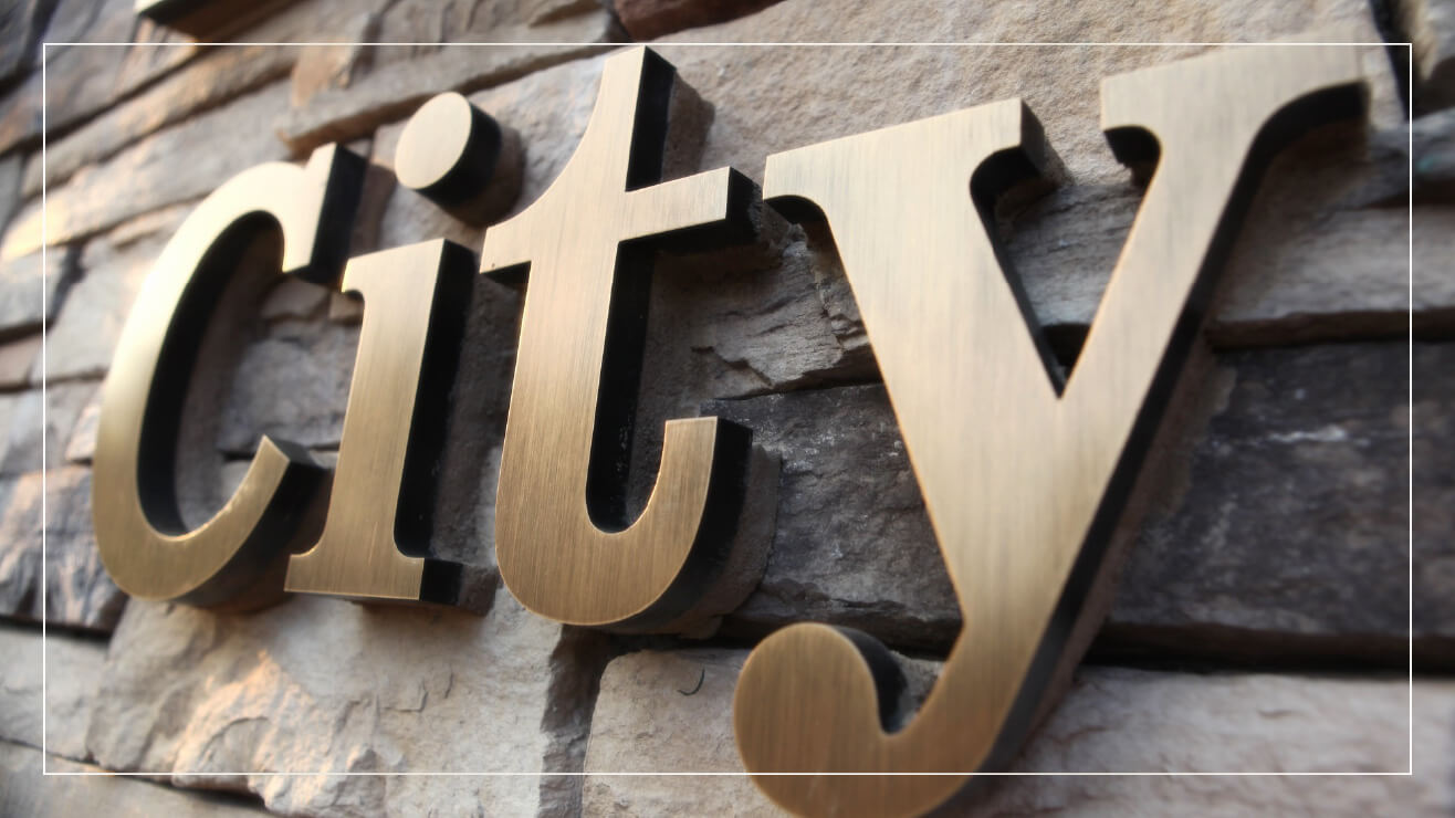 Example of bronze letters on a stone wall.