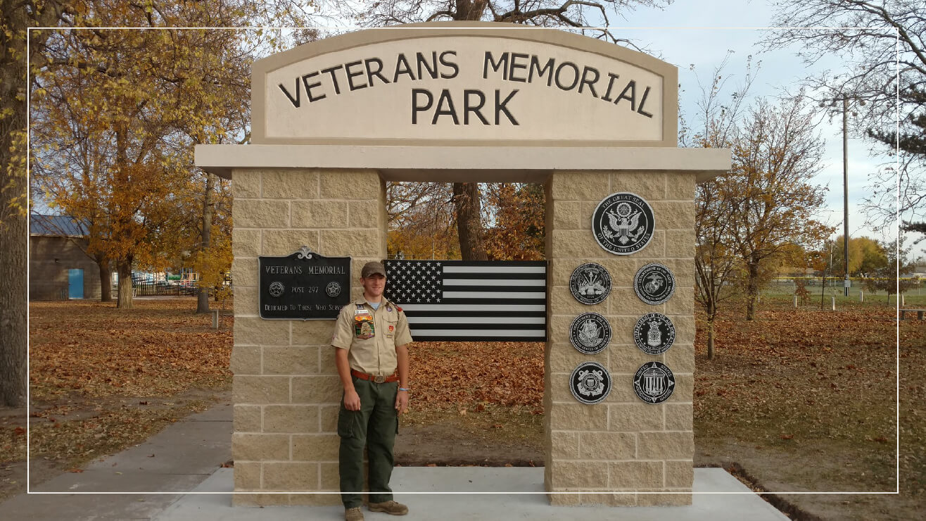 Aluminum military plaques and letters at a veterans memorial. 