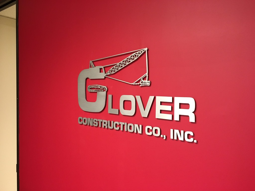 Brushed Finish Aluminum logo on Red painted wall