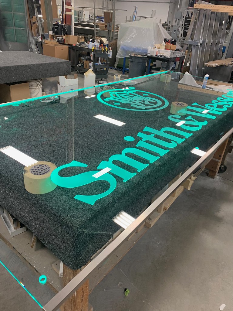 Detail of RGB LED edge lit glass panel sign