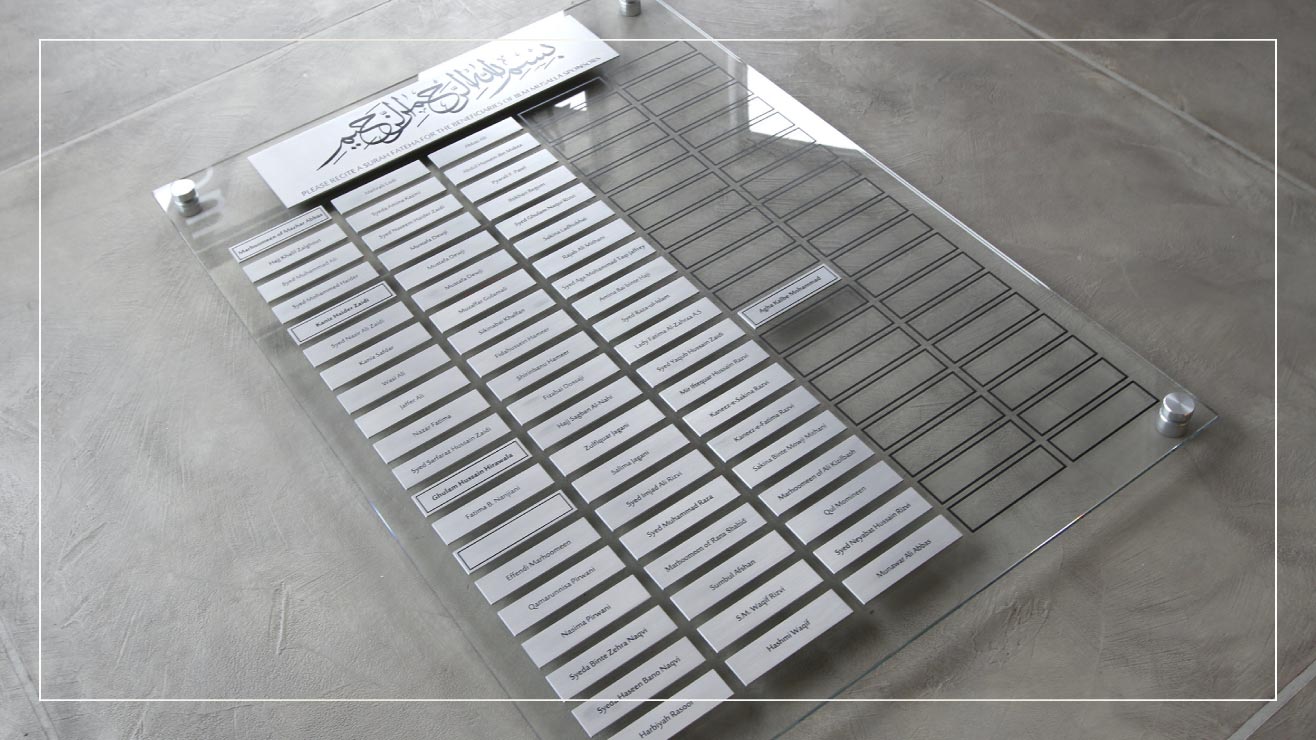 A glass panel has etched stainless steel panels with the names of donors.