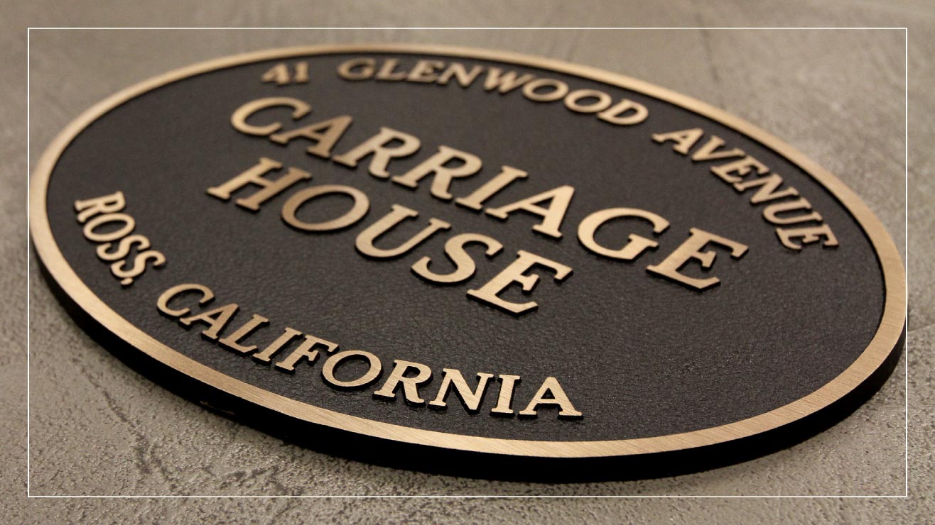 An example cast metal address plaque from Impact Signs.