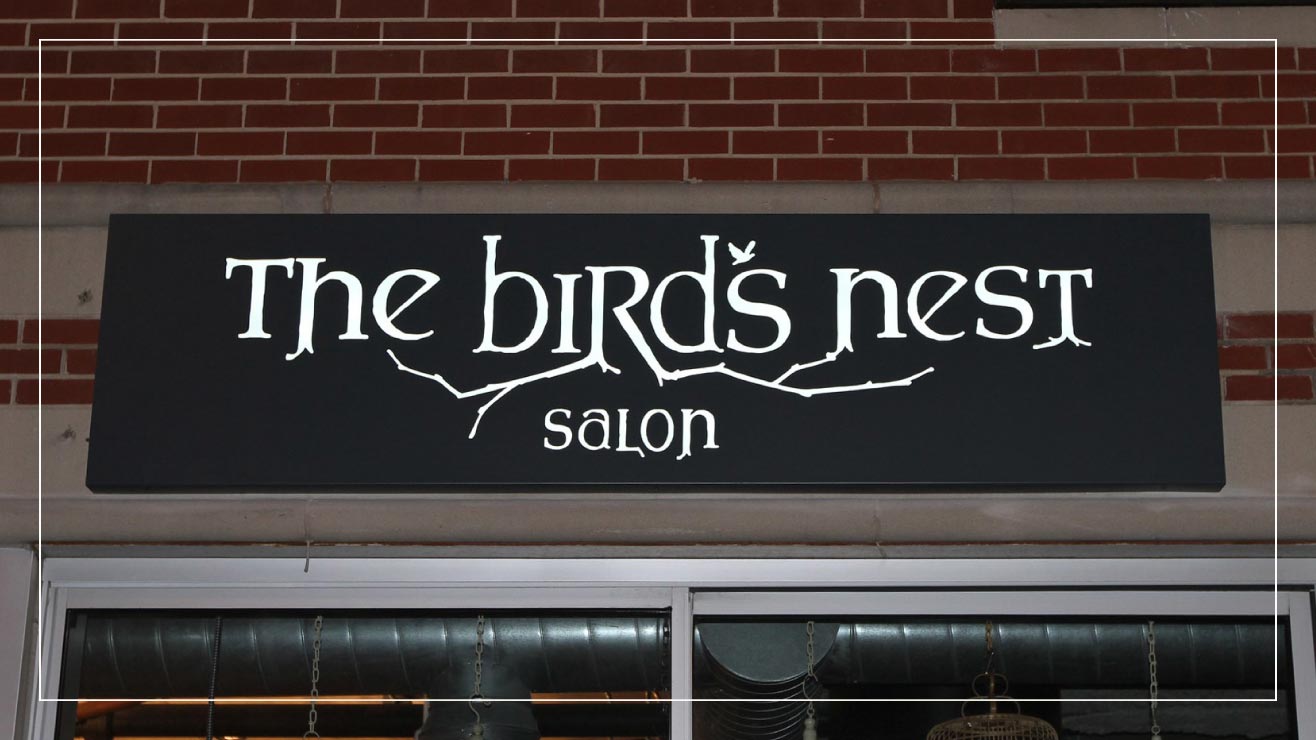 An example fabricated metal exterior lighted panel sign from Impact Signs.