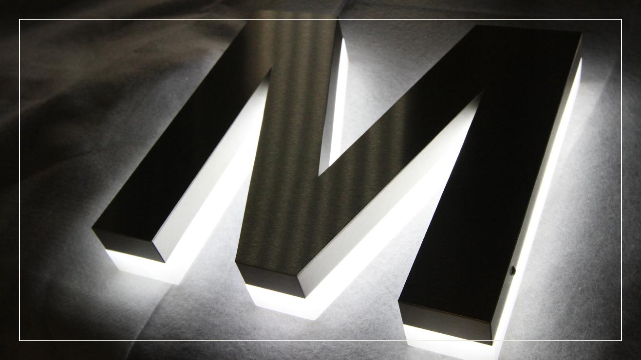 An example of fabricated stainless steel lettering with backlighting.