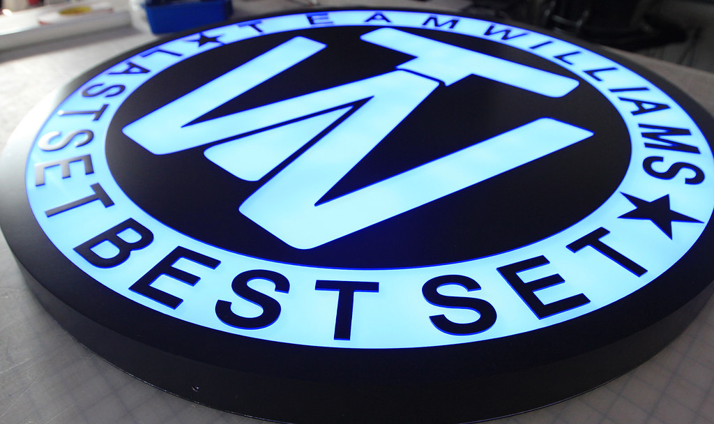 Fabricated circle panel signs with reverse cut logo graphics for RGB lighting interior or exterior use