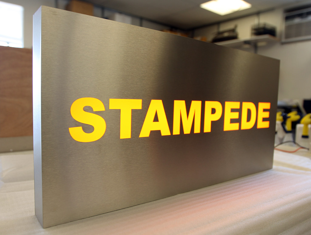Fabricated panel sign with cut out accent lighted letters