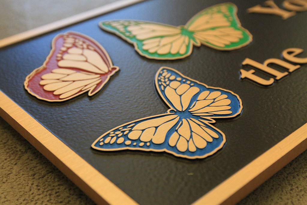 full color paint filled line art detail on bronze plaque