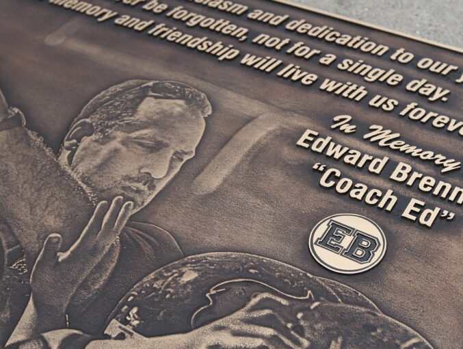 Full photo relief bronze memorial plaque for Coach Ed with custom logo on face