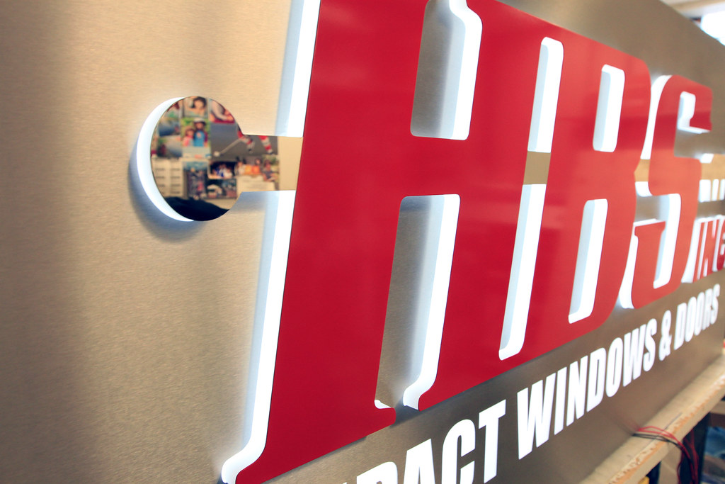 Lighted Lobby Sign Fabricated stainless steel panel with pushthru acrylic letters and graphics for edge lighting detail