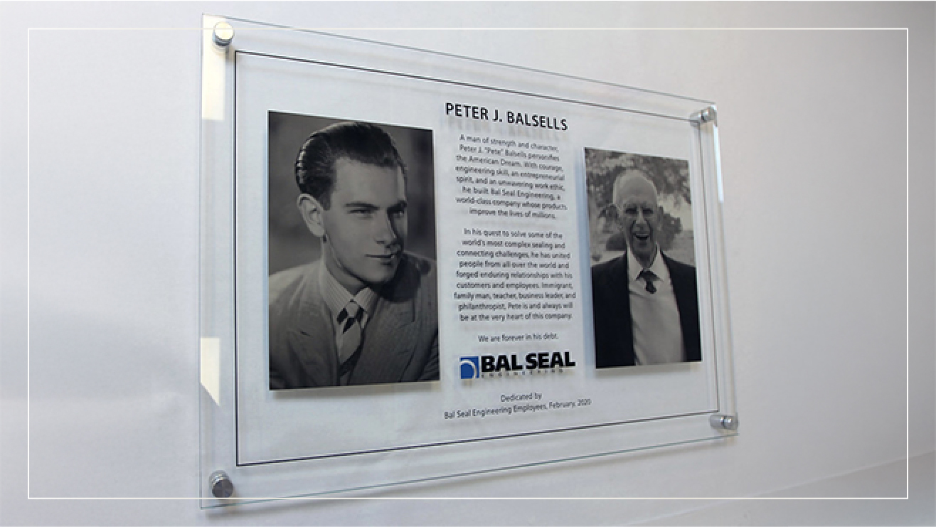 Example memorial plaque on glass for Peter J. Balsells.