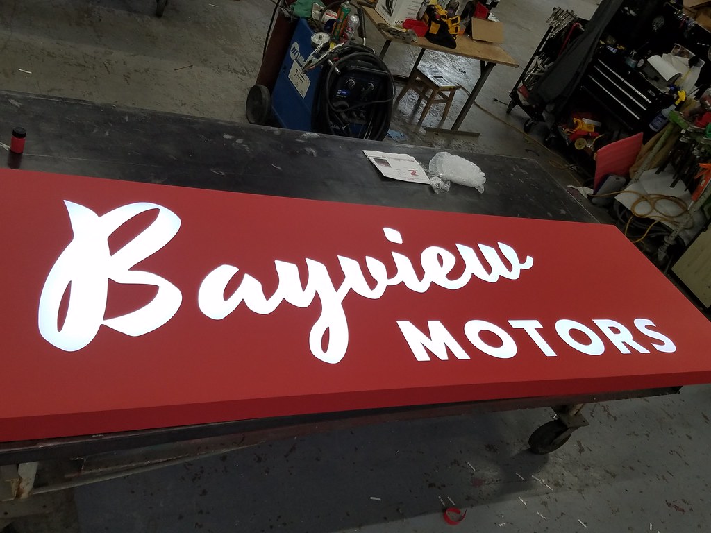 Overall 3ft x 10ft. x 3" deep fabricated aluminum panel reverse cut out letters and logo Panel painted custom red pantone Cool White LED illumination Includes power supplies and angle brackets for hanging.