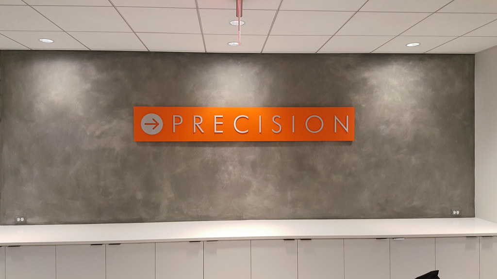 Painted Orange Aluminum panel with Brushed aluminum logo and lettering assembled on face