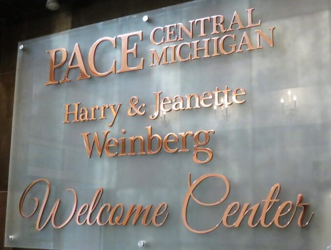 Polished copper lettering assembled on frosted glass panel